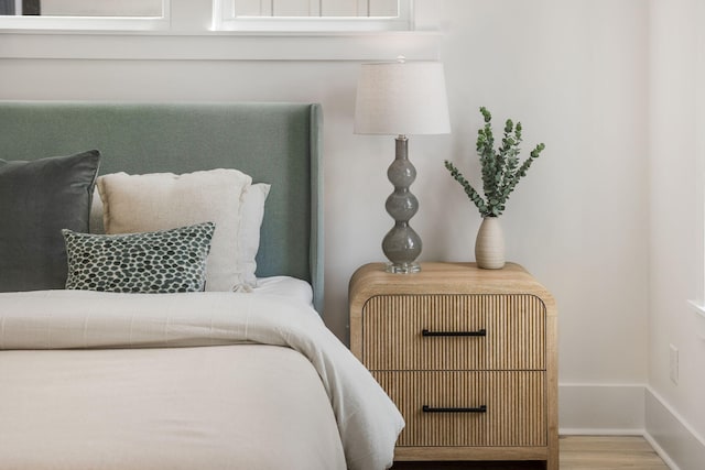 bedroom with baseboards and wood finished floors