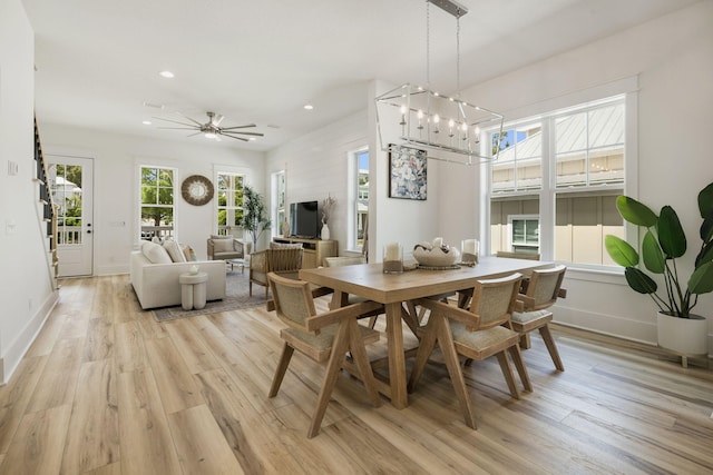 dining room with baseboards, light wood-style floors, recessed lighting, and ceiling fan with notable chandelier