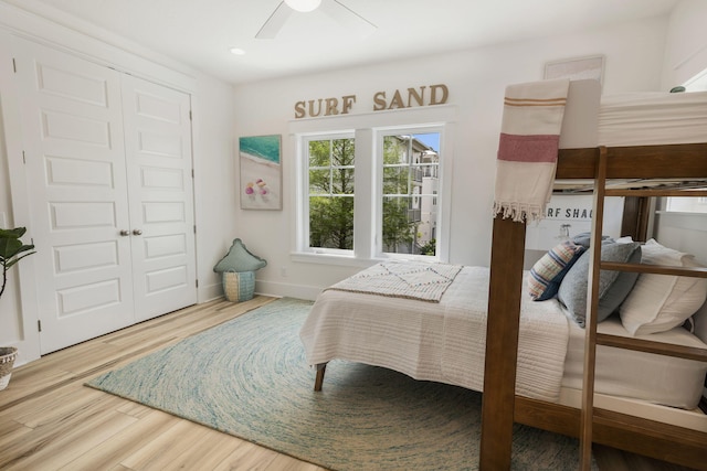 bedroom with a closet, recessed lighting, baseboards, ceiling fan, and wood finished floors