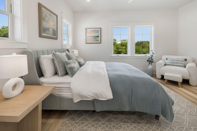 bedroom featuring recessed lighting, multiple windows, and dark wood-style floors