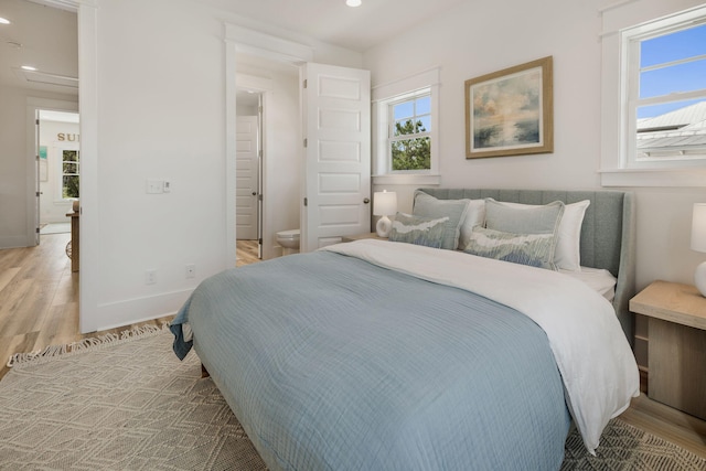bedroom featuring baseboards, light wood-style floors, and recessed lighting