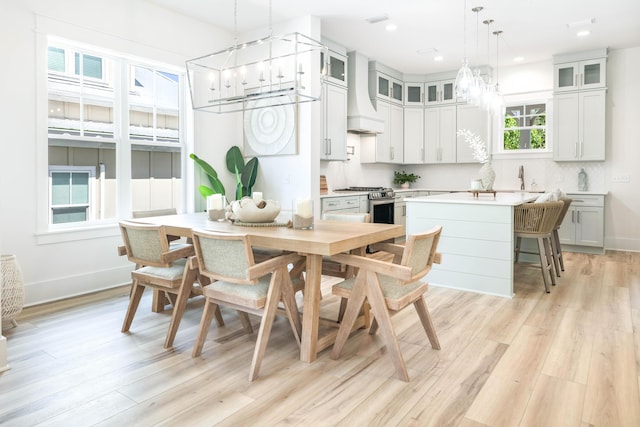 174 Grande Pointe Cir, Inlet Beach, FL 32461 - kitchen featuring a chandelier, stainless steel range with gas stovetop, light wood-style flooring, custom exhaust hood, and recessed lighting
