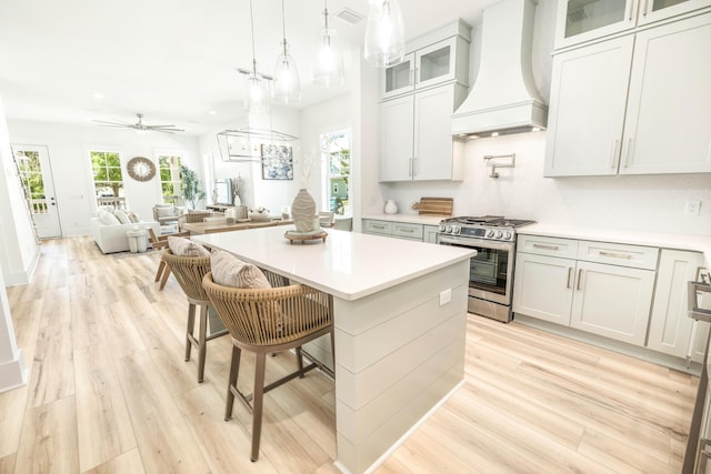 174 Grande Pointe Cir, Inlet Beach, FL 32461 - kitchen featuring custom range hood, stainless steel gas range, light wood-type flooring, light countertops, and recessed lighting