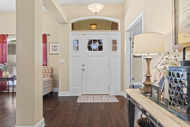 entryway featuring baseboards and dark wood-style floors