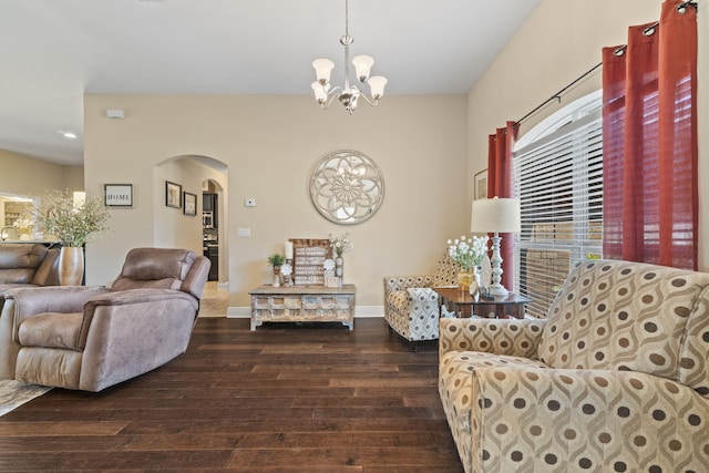 living room featuring arched walkways, baseboards, wood-type flooring, an inviting chandelier, and recessed lighting