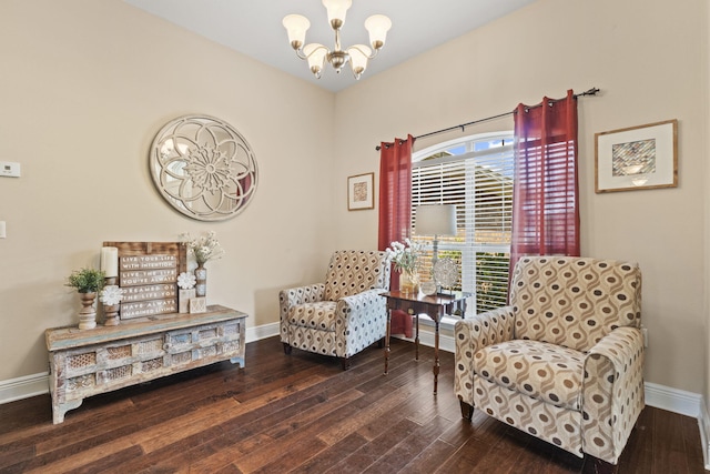 sitting room featuring baseboards, a chandelier, and wood finished floors
