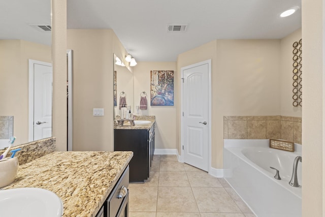 bathroom featuring visible vents, baseboards, a bath, tile patterned floors, and two vanities