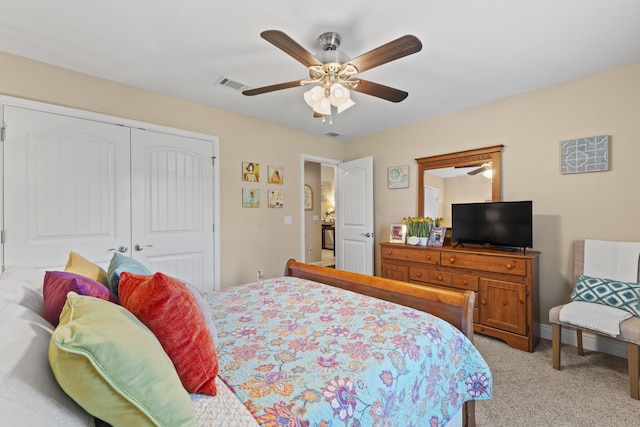 bedroom featuring ceiling fan, a closet, light colored carpet, and visible vents