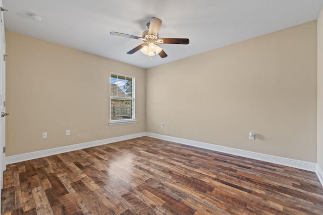 unfurnished room with dark wood-type flooring, baseboards, and ceiling fan
