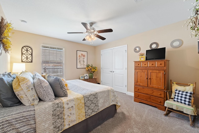 bedroom with a closet, carpet, ceiling fan, and baseboards