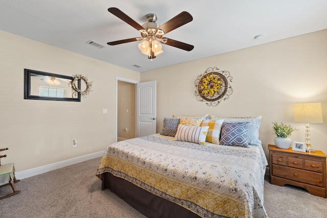 carpeted bedroom with baseboards, a ceiling fan, and visible vents