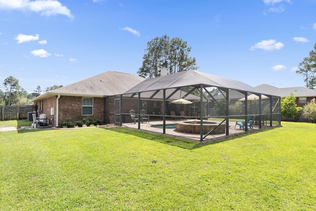 back of property with fence, brick siding, a fenced in pool, a patio, and a yard