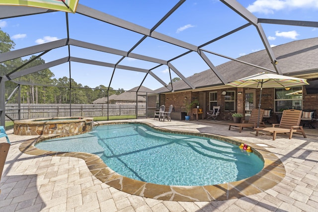 view of pool featuring a fenced backyard, a patio, a pool with connected hot tub, and glass enclosure
