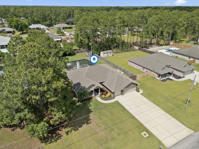 bird's eye view with a wooded view