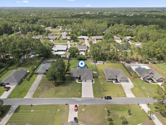 bird's eye view featuring a residential view and a forest view