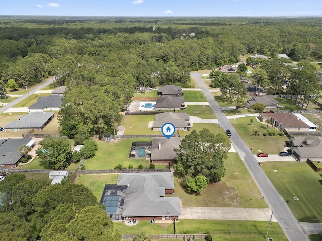 bird's eye view featuring a view of trees and a residential view