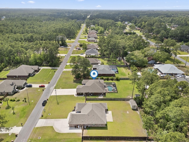 aerial view featuring a view of trees and a residential view