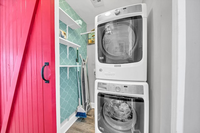 10519 Front Beach Rd Unit 1802B, Panama City Beach, FL 32407 - laundry room with laundry area, stacked washing maching and dryer, wood finished floors, and visible vents