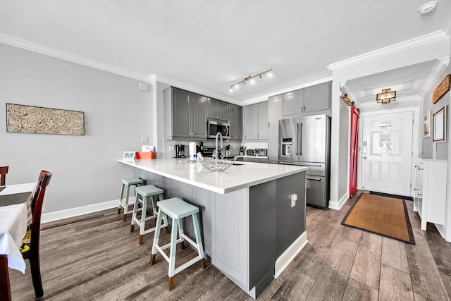 10519 Front Beach Rd Unit 1802B, Panama City Beach, FL 32407 - kitchen with gray cabinetry, appliances with stainless steel finishes, ornamental molding, and a peninsula