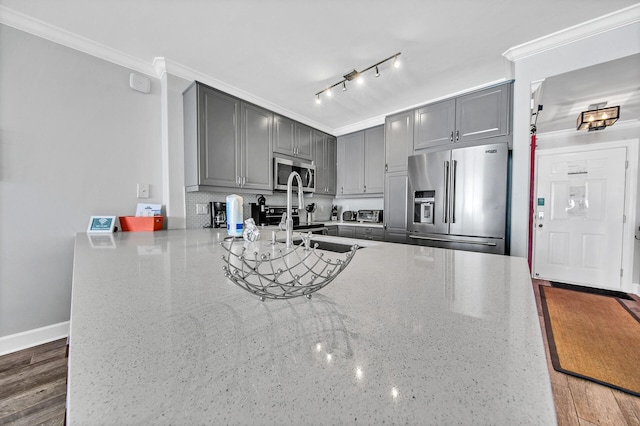10519 Front Beach Rd Unit 1802B, Panama City Beach, FL 32407 - kitchen with a peninsula, appliances with stainless steel finishes, ornamental molding, and gray cabinets