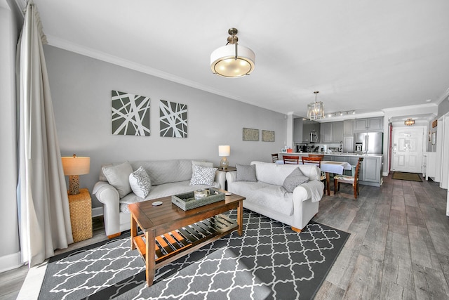 10519 Front Beach Rd Unit 1802B, Panama City Beach, FL 32407 - living area featuring ornamental molding, dark wood-style flooring, and a notable chandelier