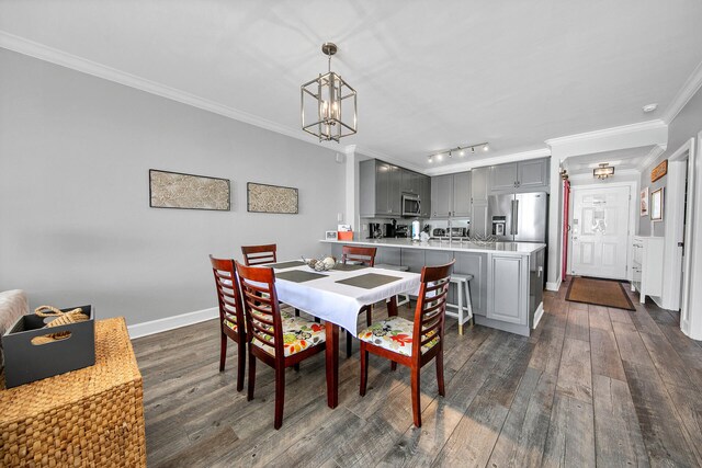 10519 Front Beach Rd Unit 1802B, Panama City Beach, FL 32407 - dining area featuring an inviting chandelier, dark wood finished floors, and crown molding