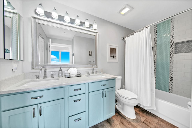 10519 Front Beach Rd Unit 1802B, Panama City Beach, FL 32407 - bathroom with a sink, shower / bath combo, toilet, and wood finished floors