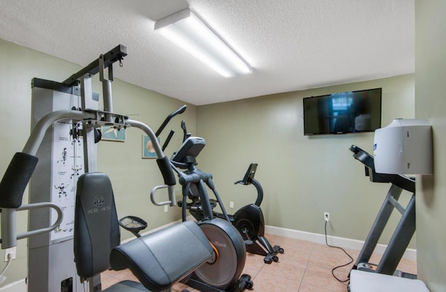 10519 Front Beach Rd Unit 1802B, Panama City Beach, FL 32407 - exercise room with baseboards, a textured ceiling, and tile patterned floors