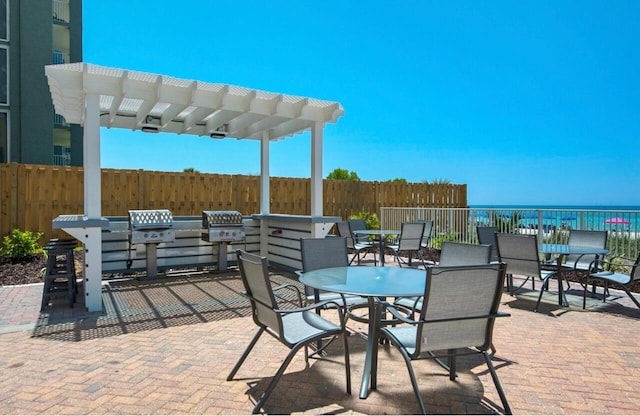 10519 Front Beach Rd Unit 1802B, Panama City Beach, FL 32407 - view of patio / terrace with fence, outdoor dining space, grilling area, and a pergola