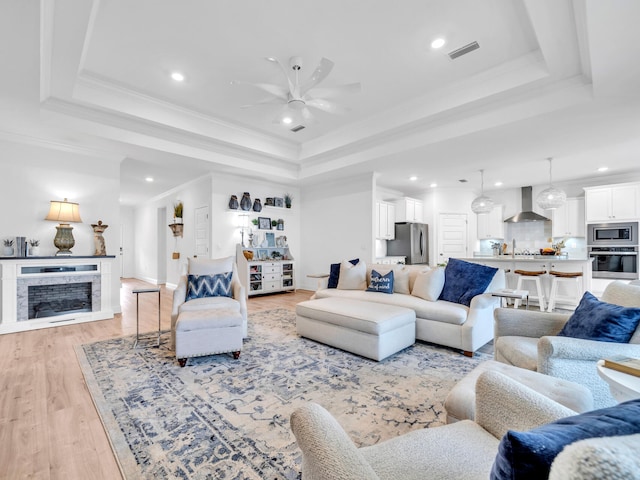 183 Pine Lake Dr, Santa Rosa Beach, FL 32459 - living room with a raised ceiling, ceiling fan, recessed lighting, and light wood-style flooring