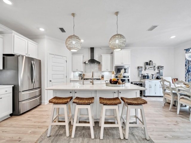 183 Pine Lake Dr, Santa Rosa Beach, FL 32459 - kitchen with visible vents, wall chimney range hood, light countertops, tasteful backsplash, and stainless steel appliances