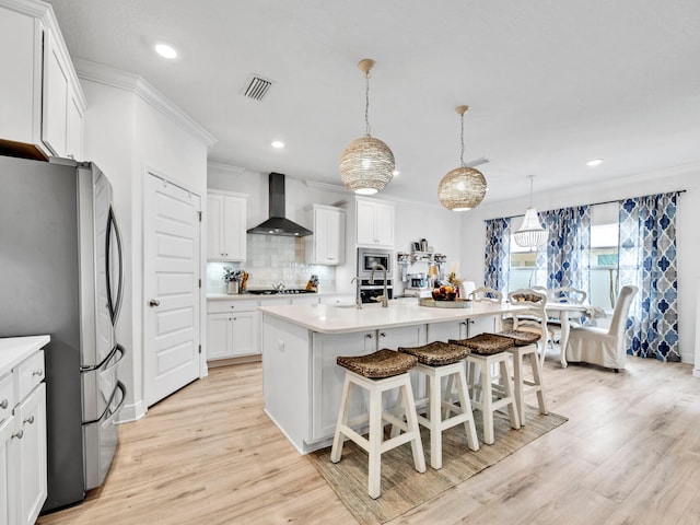 183 Pine Lake Dr, Santa Rosa Beach, FL 32459 - kitchen featuring decorative backsplash, appliances with stainless steel finishes, light wood-style floors, recessed lighting, and wall chimney exhaust hood