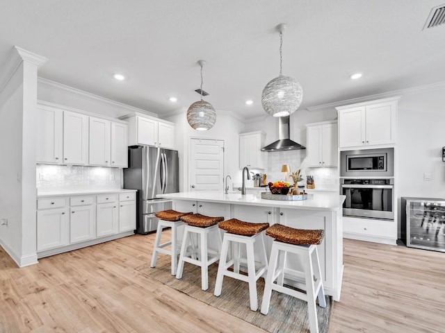 183 Pine Lake Dr, Santa Rosa Beach, FL 32459 - kitchen featuring wall chimney range hood, tasteful backsplash, ornamental molding, and stainless steel appliances