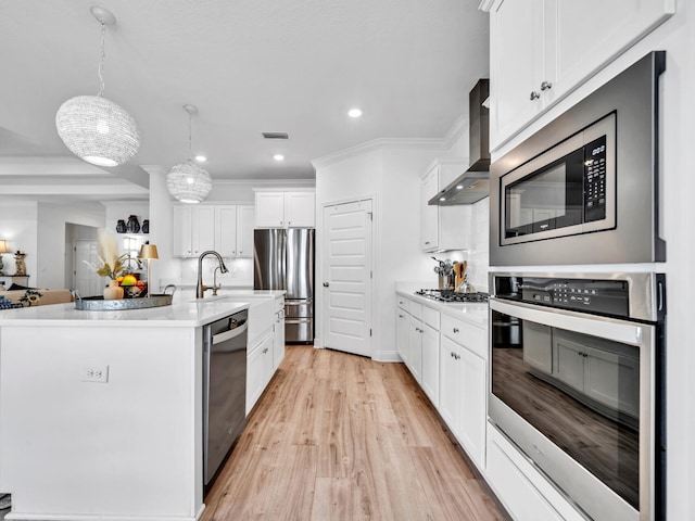 183 Pine Lake Dr, Santa Rosa Beach, FL 32459 - kitchen featuring wall chimney range hood, light countertops, white cabinets, light wood finished floors, and stainless steel appliances