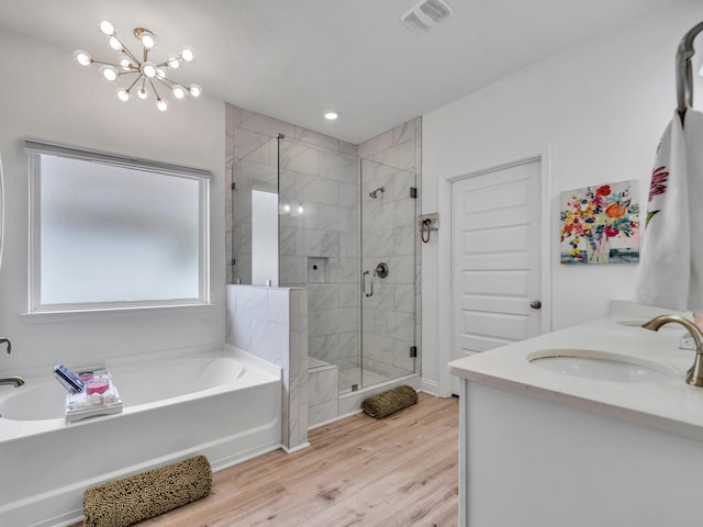 183 Pine Lake Dr, Santa Rosa Beach, FL 32459 - full bathroom with a sink, wood finished floors, visible vents, a garden tub, and a stall shower