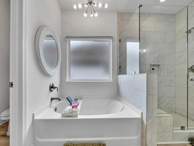 183 Pine Lake Dr, Santa Rosa Beach, FL 32459 - bathroom with a bath, a stall shower, a notable chandelier, and toilet