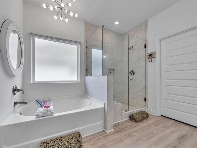 183 Pine Lake Dr, Santa Rosa Beach, FL 32459 - bathroom featuring a notable chandelier, a stall shower, a bath, and wood finished floors