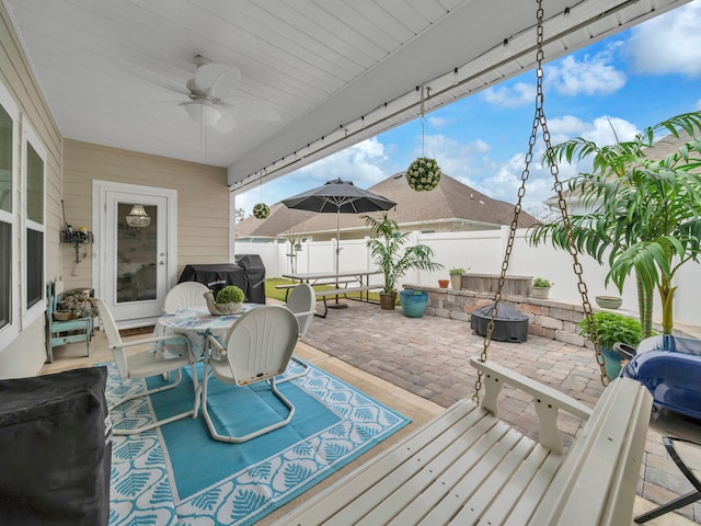 183 Pine Lake Dr, Santa Rosa Beach, FL 32459 - deck featuring a fenced backyard, a ceiling fan, a patio, and a fire pit