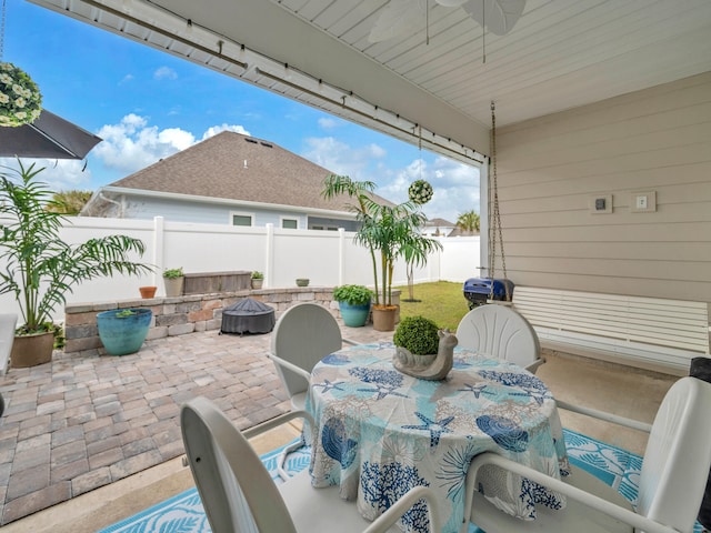 183 Pine Lake Dr, Santa Rosa Beach, FL 32459 - view of patio / terrace featuring outdoor dining area, a fenced backyard, a ceiling fan, and an outdoor fire pit