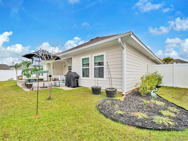 183 Pine Lake Dr, Santa Rosa Beach, FL 32459 - rear view of property featuring a yard, a patio, and a fenced backyard
