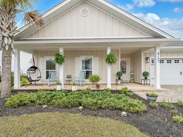 183 Pine Lake Dr, Santa Rosa Beach, FL 32459 - view of front of home featuring covered porch, an attached garage, and board and batten siding