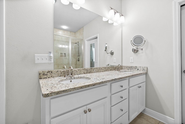 672 Alderberry Rd, Santa Rosa Beach, FL 32459 - bathroom with baseboards, a sink, double vanity, and a shower stall