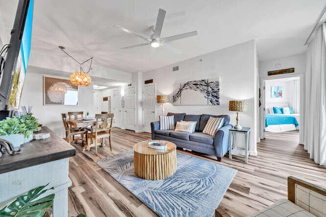 living room featuring ceiling fan and light wood-style flooring