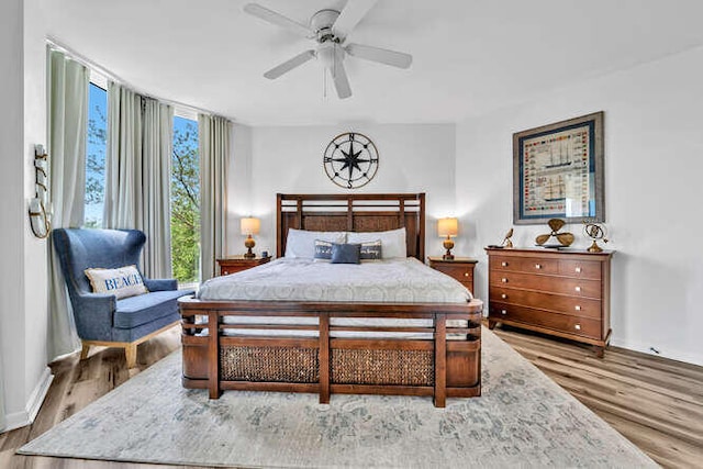 bedroom with baseboards and wood finished floors