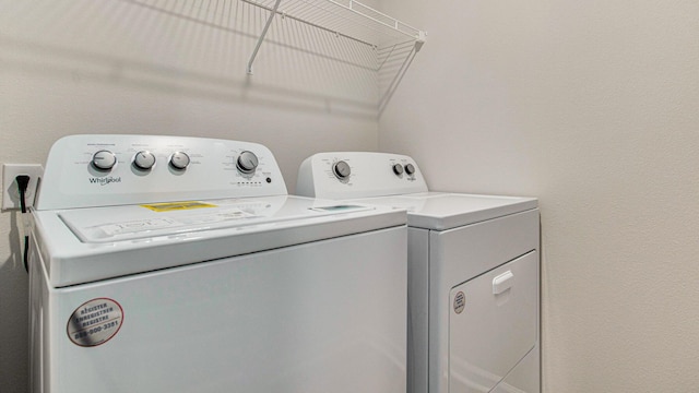 3074 Heritage Plantation Blvd, Laurel Hill, FL 32567 - laundry area with a textured wall and washer and clothes dryer