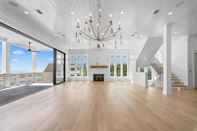unfurnished living room with visible vents, wooden ceiling, wood finished floors, and a fireplace