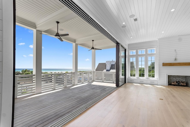 interior space with a water view and beam ceiling