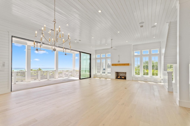 unfurnished living room featuring a notable chandelier, a fireplace, recessed lighting, wood finished floors, and wood ceiling