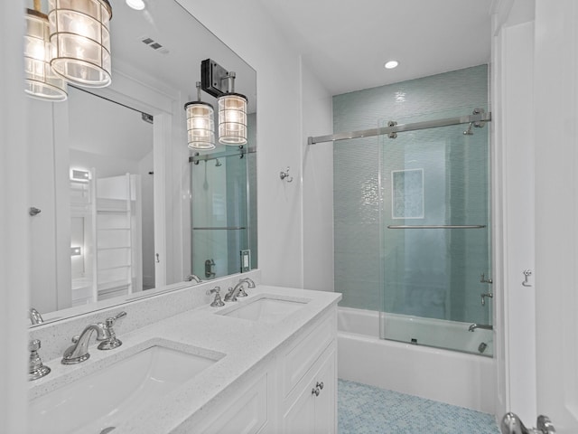 bathroom with a sink, double vanity, recessed lighting, and shower / bath combination with glass door