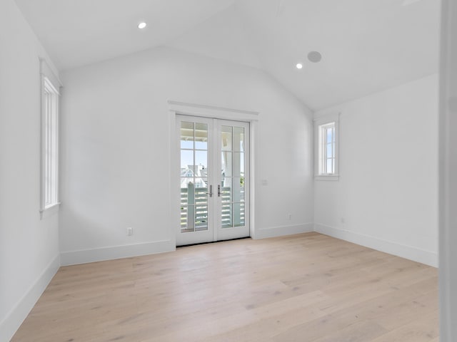 unfurnished room featuring recessed lighting, vaulted ceiling, and light wood finished floors